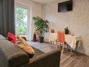 a living room with a couch and a table at Workershome - Business Apartments - Monteurwohnungen in Wertheim