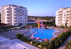 a large pool with a water slide in a resort at Watercastle Suites in Erdemli