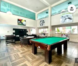 a billiard room with a pool table in it at Apartamento Maravilhoso,condominio com piscina aquecida coberta e mais 2 externas. in Bombinhas