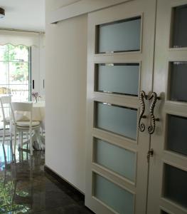 a door with glass panels in a dining room at Melaike Hotel in Foça