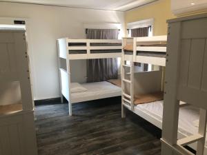 a room with three bunk beds in a room at The Wilshire Metro in Los Angeles
