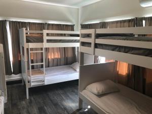 a room with three bunk beds in a room at The Wilshire Metro in Los Angeles