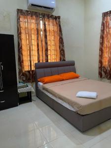 A bed or beds in a room at Faris's Homestay & Resort