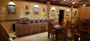 a restaurant with a bar with a table and chairs at Tringa Villas Yala in Kirinda