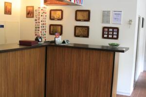 a reception counter in a hospital room with pictures on the wall at Hotel Mettmann in Mettmann