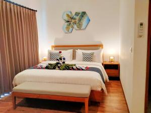 a bedroom with a large bed with at Villa Ataya in Lovina