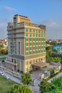 a hotel building with a sign on top of it at Goldfinch Hotel Delhi NCR in Faridabad