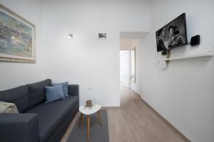a living room with a couch and a table at Naval apartment in Rijeka