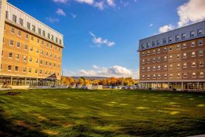 two buildings and a grassy field between two buildings at Memorial University in St. John's