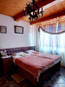 a bedroom with a large bed and a window at Guest House Marketti in Vynohradiv