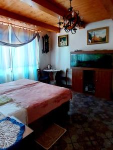 a bedroom with a bed and a large window at Guest House Marketti in Vynohradiv