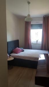 a bedroom with a large bed with a window at Czartoryskiego 32 in Wrocław