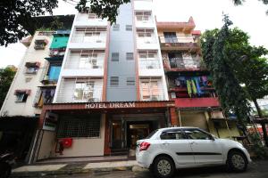 a white car parked in front of a building at Hotel Dream Residency in Navi Mumbai