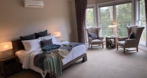 a bedroom with a bed and a chair at Kerami Manor & Day Spa in Marysville