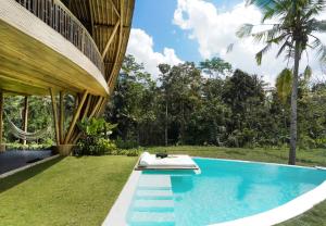 a swimming pool in the backyard of a house at Eco Six Bali in Tampaksiring