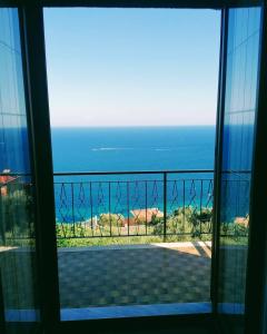 a room with a view of the ocean from a balcony at Casa Bellavista in Bergeggi