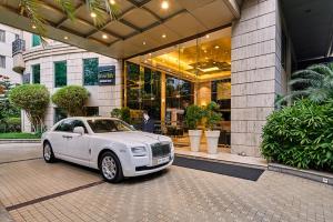 a white car parked in front of a building at Goldfinch Hotel Bangalore in Bangalore