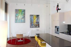 a kitchen with a table and yellow chairs at Beautiful Loft In The Center Of Lausanne in Lausanne