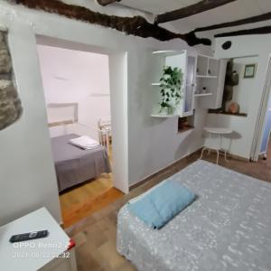 a small room with two beds and a table at Casa nella roccia in Bomarzo