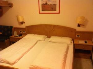 Voodi või voodid majutusasutuse Piccolo Hotel Sciliar toas