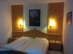 Voodi või voodid majutusasutuse Piccolo Hotel Sciliar toas