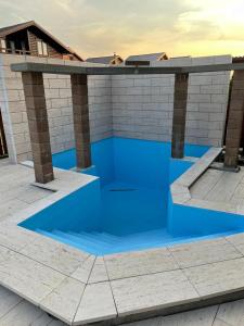 a swimming pool with blue water in a building at Cabana The Lux in Beclean