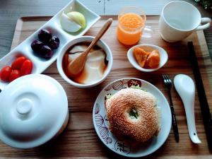 a wooden table with a plate of food with a donut on it at Matsu Seaside View Homestay in Nangan