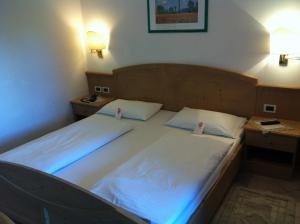 Voodi või voodid majutusasutuse Piccolo Hotel Sciliar toas
