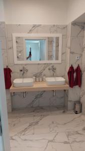 a bathroom with two sinks and a mirror at Laguna ubytovanie 2 A in Trenčín
