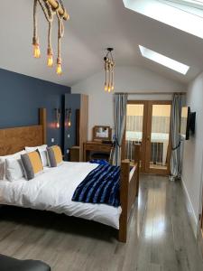 a bedroom with a bed and a desk in a room at The Forge Guest Rooms in Long Whatton