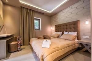 a bedroom with a large bed and a desk at Luxury Villa Zante Villa Avril 3 Bedrooms Astounding Sea Views & Private Pool & Jacuzzi Keri in Marathias