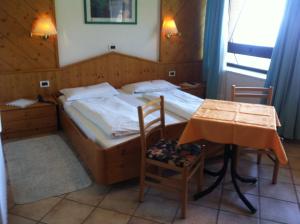 Voodi või voodid majutusasutuse Piccolo Hotel Sciliar toas