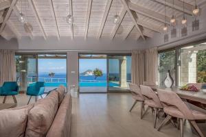 a living room with a couch and a table and chairs at Luxury Villa Zante Villa Avril 3 Bedrooms Astounding Sea Views & Private Pool & Jacuzzi Keri in Marathias