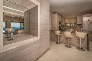 a kitchen with two stools and a large mirror at Luxury Villa Zante Villa Avril 3 Bedrooms Astounding Sea Views & Private Pool & Jacuzzi Keri in Marathias +28 photos
