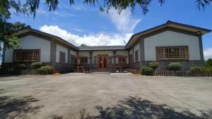 a house with a driveway in front of it at 鄉間雅築休閒民宿Country Villa Homestay in Yilan City