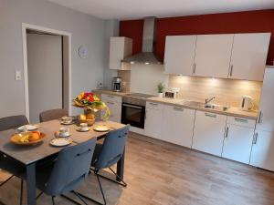 a kitchen with a table with fruit on it at Ferienwohnung Setzer Mühle in Saint-Vith