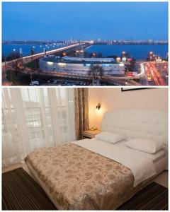 een slaapkamer met een bed en uitzicht op de stad bij Staybridge Mini-Hotel in Most City PANORAMIC RIVER VIEW in Dnipro