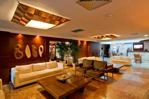 a living room with couches and a table at Pontalmar Praia Hotel in Natal