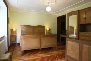 a room with a bed and a dresser at Hotel Villa Tedaldi in Gressoney-Saint-Jean