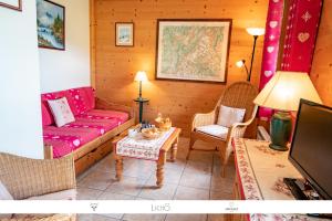 een woonkamer met een bank en een tafel bij Sur Le Feug Appt 14 in Combloux