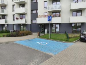 a swimming pool in front of a building at Apartament FILO in Pogórze