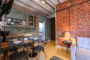 a kitchen with a brick wall and a table and chairs at Galadoo Suites 3rd Floor in Istanbul