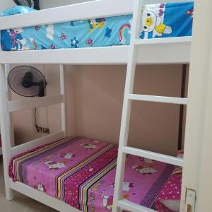 a bedroom with two bunk beds with a crib at Sweet Home Hostel - ممنوع للبنات المصرين in Hurghada