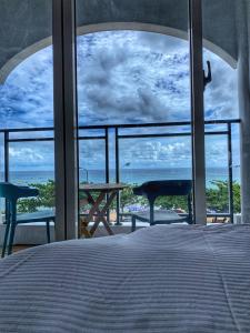 a bedroom with a bed and a view of the ocean at 南灣陽光皮小妞 Pii hostel in Nanwan