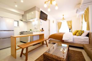 a small apartment with a bed and a kitchen at K-HOUSE Naha Maejima in Naha