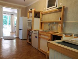 a kitchen with a refrigerator and a counter top at Willa Stary Dom in Warsaw