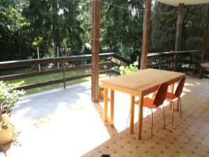 a wooden table and chairs on a patio at Willa Stary Dom in Warsaw