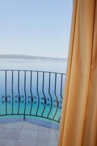 a view of the ocean from a balcony at Hotel Vali Dramalj in Crikvenica