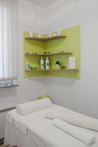 a room with two beds and shelves on the wall at Hotel Vali Dramalj in Crikvenica