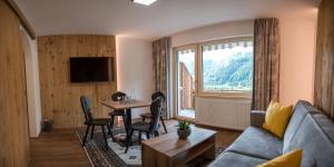een woonkamer met een bank en een tafel bij Sonnenhang Montafon in Sankt Gallenkirch
